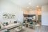 virtually staged living room with beige sofa and two grey chairs at rogers landing