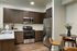 Apartments in Albany, OR with In-Unit Washer and Dryer - Creekside Meadows - Kitchen with Cabinetry, Countertops, Backsplash, Fully Equipped with Stainless Steel Appliances, a Table, and Chairs.