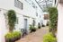 paved walkway with decorative plants near the doors
