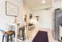 kitchen with stainless steel appliances and living room in the background
