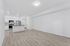 living area and kitchen with wood-style flooring, stainless steel appliances and kitchen island.