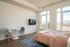 Fully Furnished Studio Floor Plan living space and bed