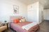 Community Guest Suite bed and living area with closet including washer & dryer