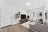 staged living room at Spring meadow with wood-style flooring and an A/C unit