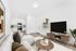 staged living room at Spring meadow with wood-style flooring and an A/C unit