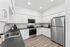 virtually staged kitchen with stainless steel appliances, white cabinets and grey countertops at Spring Meadow, in Newberg, OR
