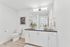 bathroom with shower/tub combo, white cabinets and grey countertops