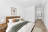 Staged primary bedroom with walk-in closet and ensuite bathroom