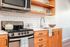 Kitchen and living area with original hardwood floors at Fairmount in Portland, OR