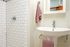 bathroom with shower and pedestal sink at Fairmount Apartments located in Portland, OR