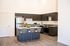 Staged kitchen with island at Pacific Ridge in Tigard, OR