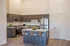 Staged kitchen with island at Pacific Ridge in Tigard, OR