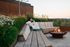 woman by fire pit on rooftop deck near dusk