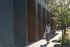 woman walking near Walden's Exterior
