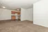 carpeted living room and kitchen in the background