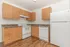 kitchen with white appliances and wood like flooring