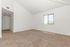 carpeted living room with window