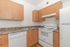 kitchen with white appliances and wood-like flooring