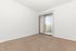 carpeted living with sliding glass door to patio/balcony
