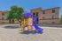 playground and three story apartment building in the background