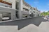 Pet-Friendly Apartments in Tigard, OR - Pacific Ridge Apartments - An Integrated Garage Parking Below the Apartments, with Parked Cars and View of the Apartment Staircase and Balconies.