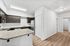 kitchen with stainless steel appliances and hallway