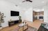 living room with kitchen with stainless steel appliances