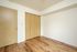 Bedroom with closet and wooden floor.