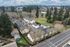 Aerial drone shot of property and surrounding area showing woodland with lots of trees alongside the road and natural horizon