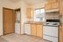 Kitchen showing in-unit laundry, dishwasher, and oven.