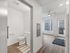 Modern studio apartment entryway and bathroom at Koz on 4th.