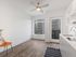Bright studio living area with hardwood-style flooring at Koz on 4th.