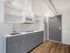 Compact, modern kitchen design with stainless steel sink at Koz on 4th.