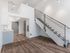 Loft living area with a modern staircase and neutral tones at Koz on 4th.