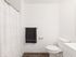 Clean, modern bathroom featuring a white shower and vanity at Koz on 4th.