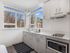 Contemporary kitchen with range and expansive windows at Koz on 13th.