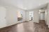 Living area with wood floors, ground floor view, kitchen, and closets