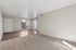 Living area with wooded entrance and carpet and view of stairs