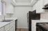Kitchen with sink, refrigerator, oven, and cupboards