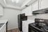 Kitchen with sink, refrigerator, oven, and cupboards