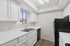 Kitchen with sink, refrigerator, oven, and cupboards