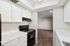 Kitchen with oven, wooden floors, and cupboards