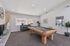 Games room with pool table, seating, plants, and windows