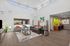 Community area with seating, TV, business section, high ceilings and windows