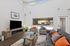 Community area with seating, TV, high ceilings and windows