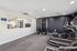 Fitness center with mirror, treadmill, elliptical, cable gym, and exercise bike