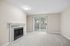 living room of C1 renovated floorplan at Timber Flats with window and fireplace
