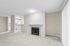 angle 2 of living room of C1 renovated floorplan at Timber Flats with fireplace and view into kitchen