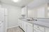 angle 2 of kitchen in C1 renovated floorplan at Timber Flats white cabinets white appliances and grey countertops