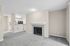 angle 2 of living room at B1 renovated floorplan at Timber Flats showing fireplace and view into kitchen